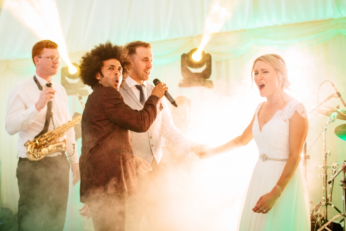 bride and groom singing at their wedding