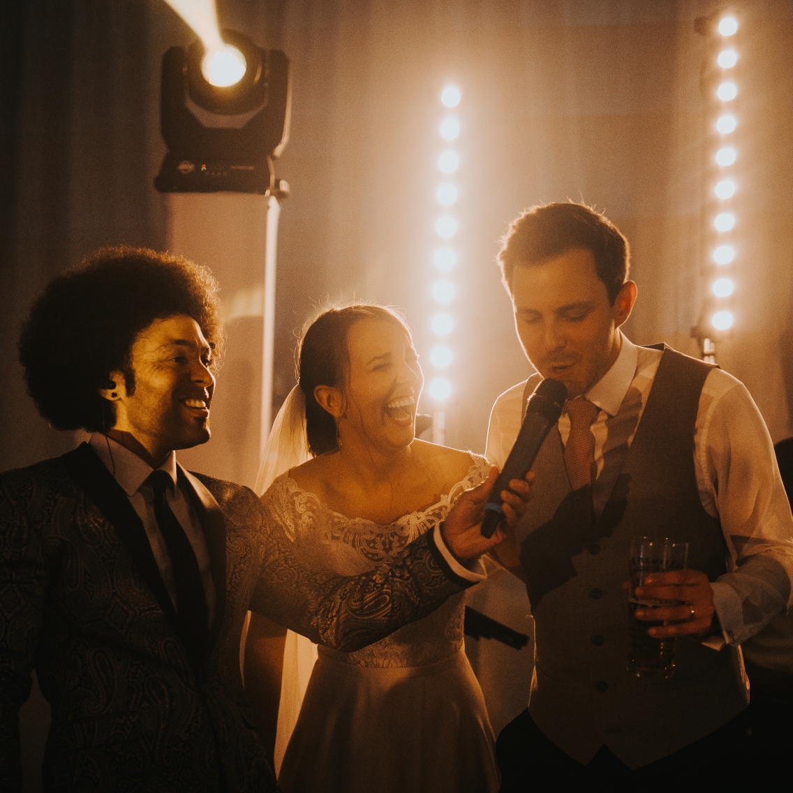 Groom singing on stage at wedding