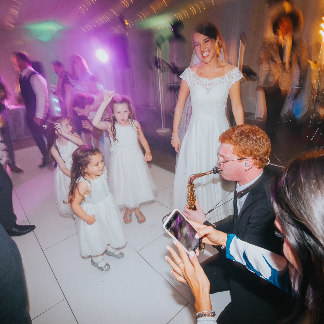 Saxophonist playing to guest on dance floor