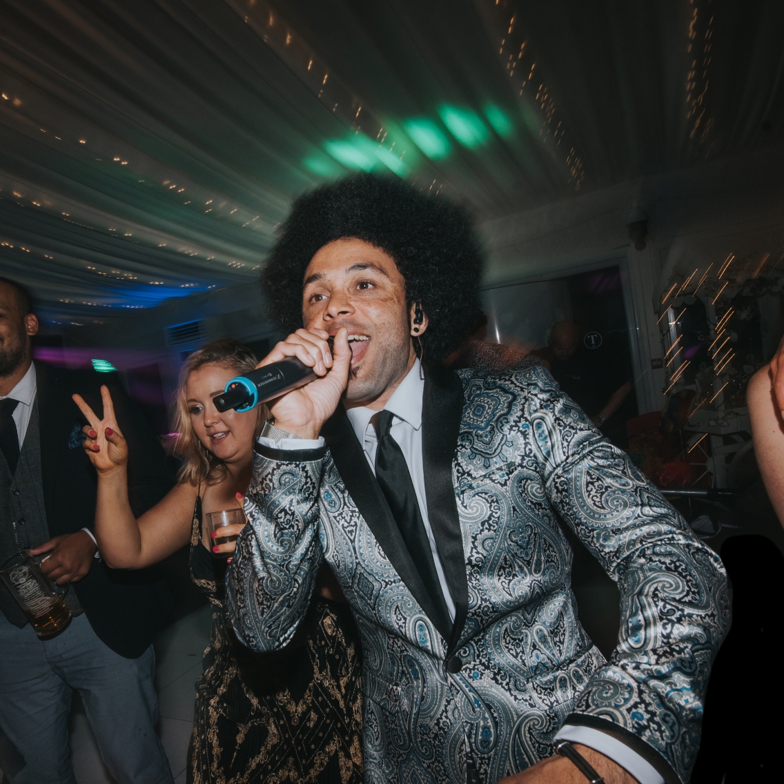 Lead singer dancing in crowd at wedding